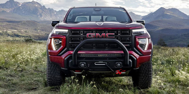 Red GMC truck in mountainous landscape