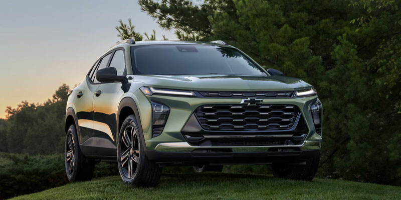 Green Chevrolet SUV parked on grass outdoors
