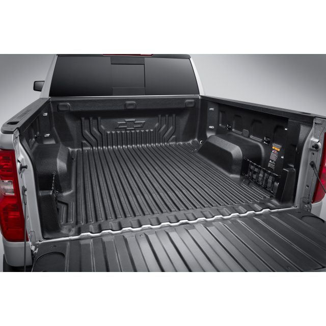 A close-up of the bed liner in the back of a pickup truck showing its textured surface for durability