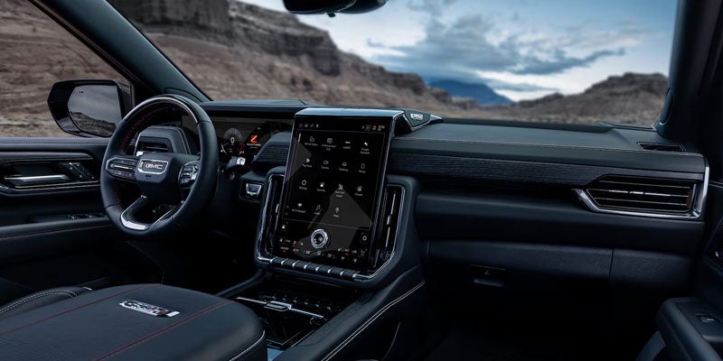 Interior of 2026 GMC Yukon in Carthage MS showing spacious three-row seating with premium leather, versatile cargo space, and upscale materials for long family trips